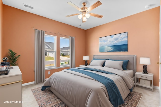 bedroom featuring light colored carpet and ceiling fan