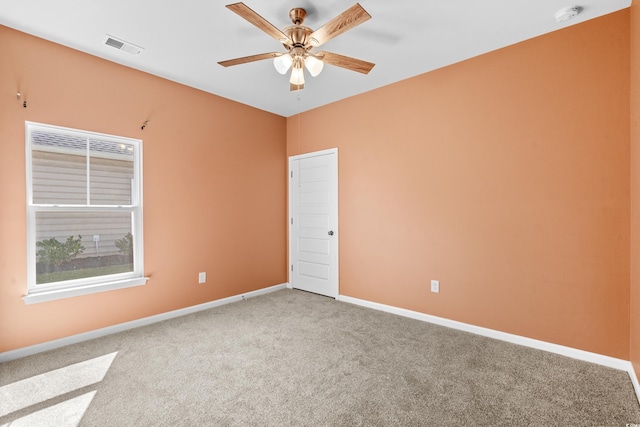 carpeted spare room with ceiling fan