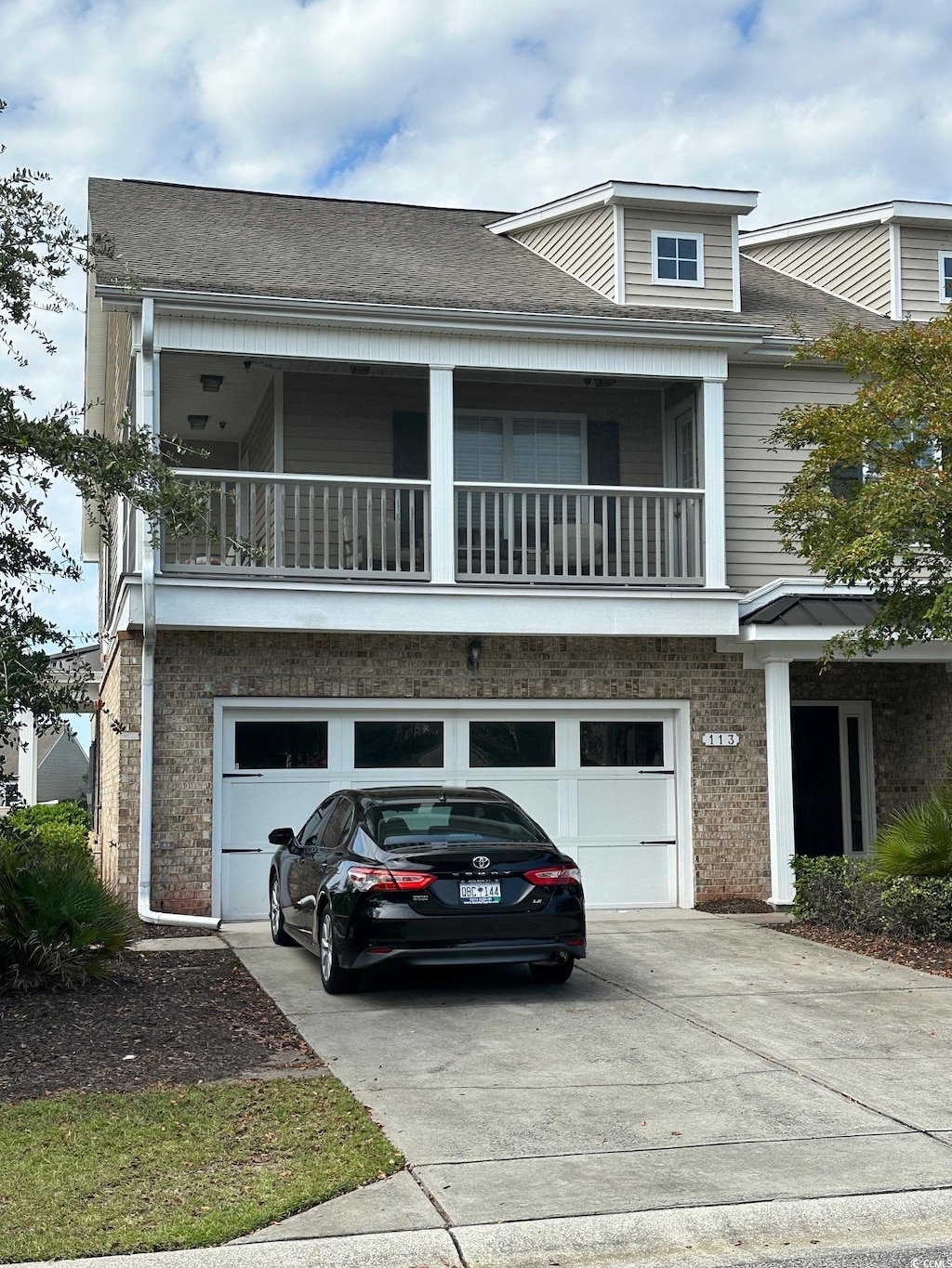 view of front of house featuring a balcony and a garage