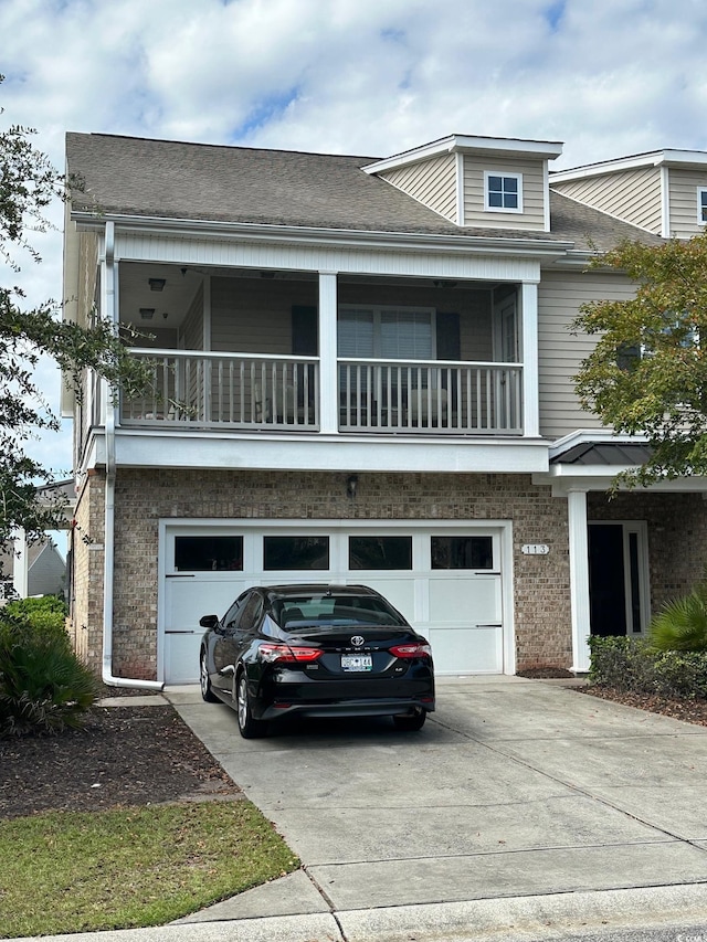 view of front of house featuring a balcony and a garage