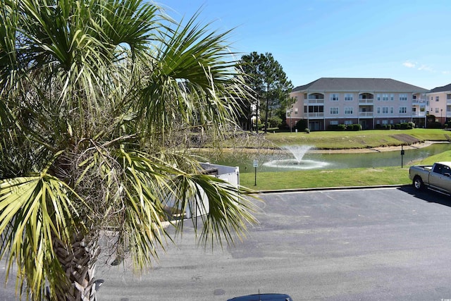 exterior space with a lawn and a water view