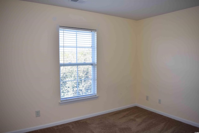 empty room featuring dark carpet