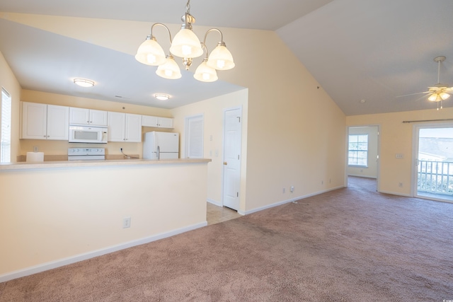 kitchen featuring lofted ceiling, light carpet, white appliances, white cabinetry, and decorative light fixtures