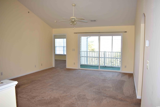 carpeted spare room featuring ceiling fan and vaulted ceiling