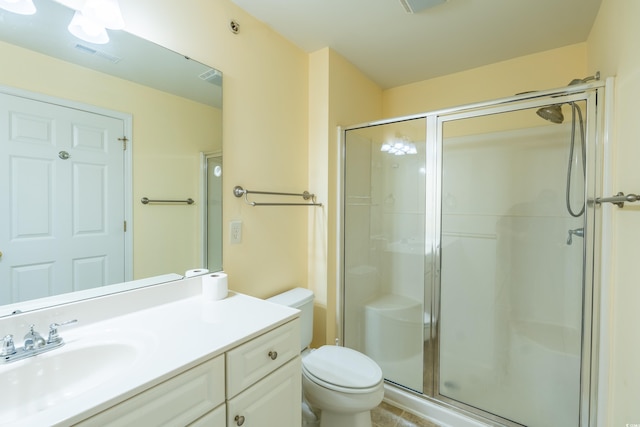 full bathroom featuring a stall shower, visible vents, vanity, and toilet