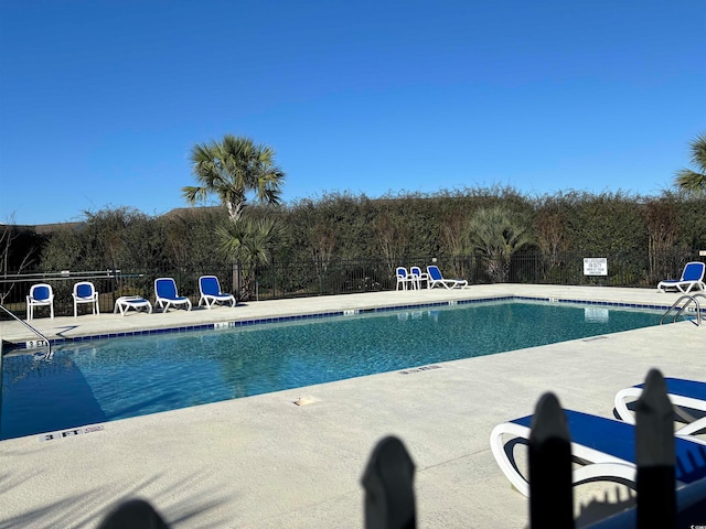 view of swimming pool featuring a patio area