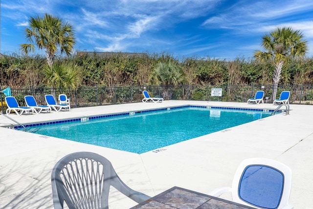 pool featuring a patio area and fence