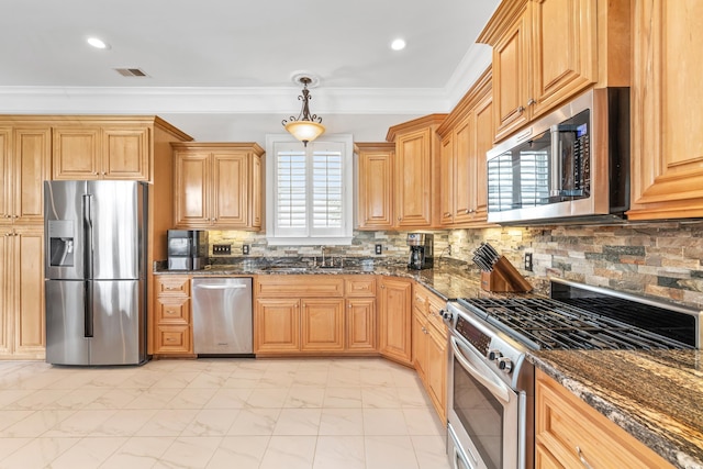 kitchen featuring appliances with stainless steel finishes, sink, ornamental molding, decorative light fixtures, and decorative backsplash