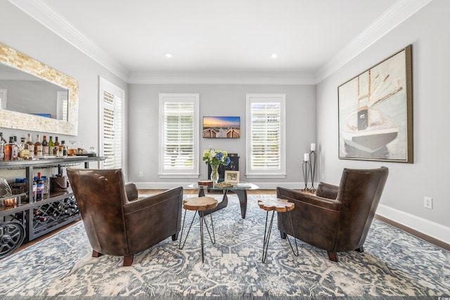 sitting room with ornamental molding, hardwood / wood-style floors, and bar