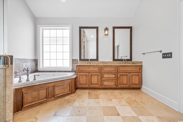 bathroom featuring a bath, lofted ceiling, and vanity