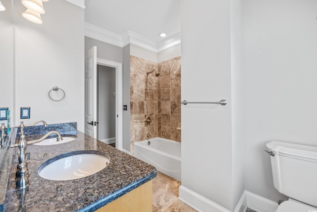 full bathroom with tile patterned floors, toilet, crown molding, tiled shower / bath combo, and vanity