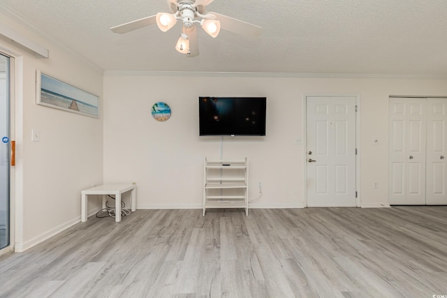 unfurnished living room featuring ceiling fan, light hardwood / wood-style floors, ornamental molding, and a textured ceiling