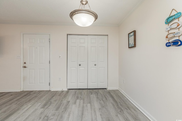 unfurnished bedroom with light hardwood / wood-style floors and crown molding