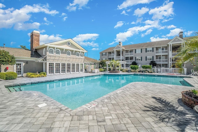 view of swimming pool featuring a patio area