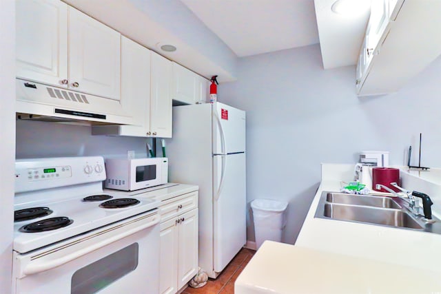 kitchen featuring white cabinets, sink, light tile patterned floors, and white appliances