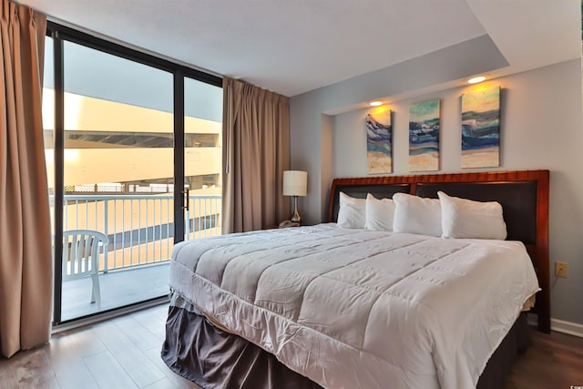 bedroom featuring access to exterior and wood-type flooring