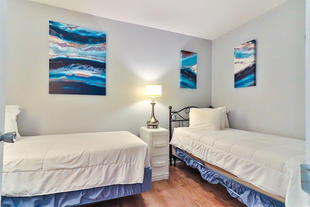 bedroom with hardwood / wood-style floors