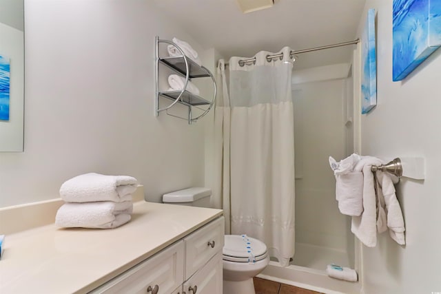 bathroom with vanity, a shower with curtain, toilet, and tile patterned floors