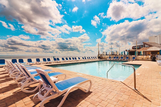 view of swimming pool with a patio area