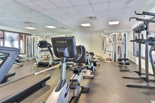 exercise room with a paneled ceiling