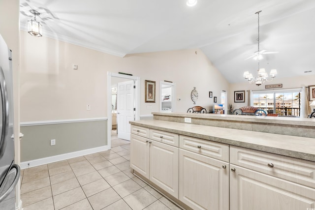 kitchen with a chandelier, vaulted ceiling, hanging light fixtures, and light tile patterned floors