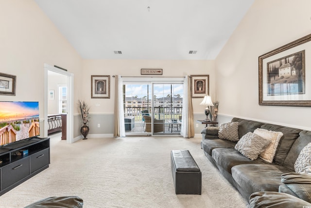 carpeted living room featuring lofted ceiling