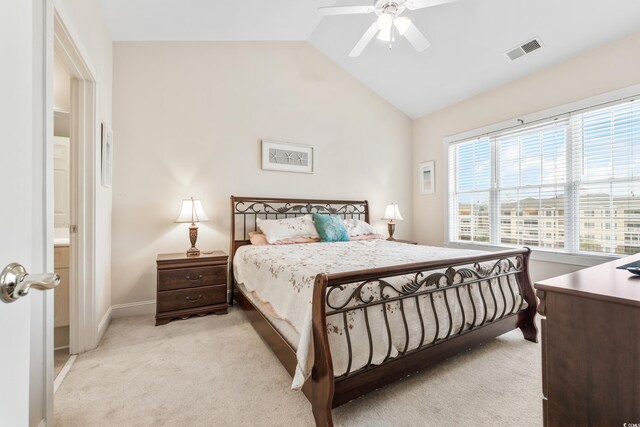 carpeted bedroom featuring lofted ceiling, ensuite bath, and ceiling fan