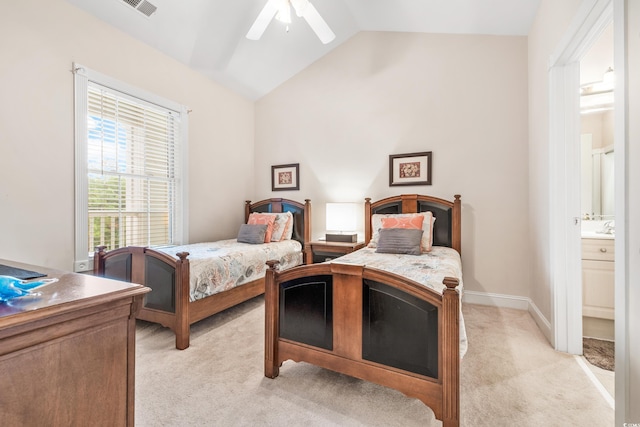 carpeted bedroom with connected bathroom, ceiling fan, vaulted ceiling, and sink