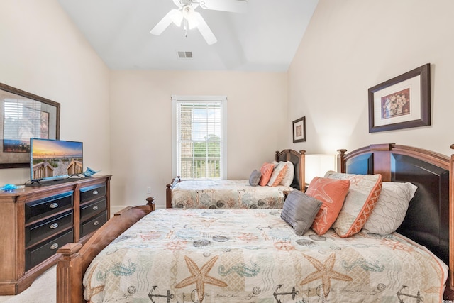 carpeted bedroom with ceiling fan and vaulted ceiling