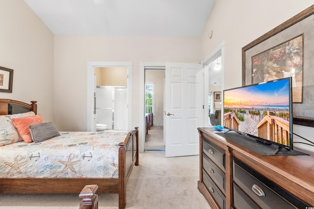 bedroom with connected bathroom and light carpet