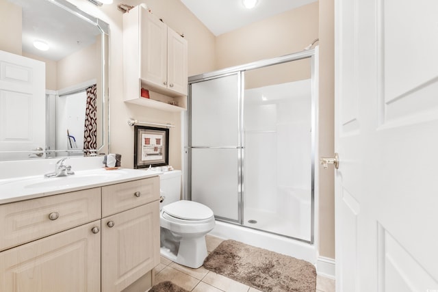 bathroom featuring vanity, an enclosed shower, toilet, and tile patterned flooring