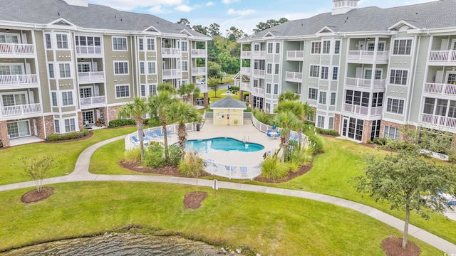 view of community featuring a gazebo, a swimming pool, and a lawn