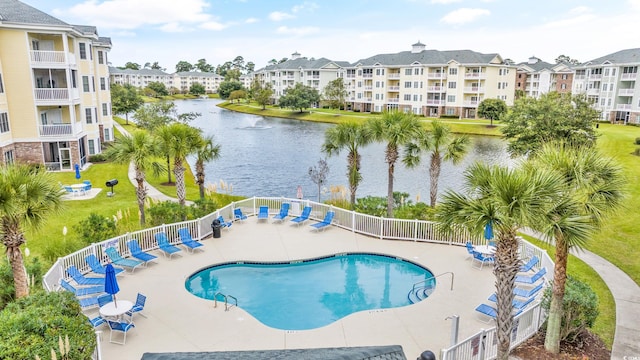 view of pool with a water view and a patio area