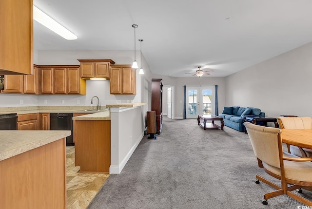 kitchen featuring light carpet, ceiling fan, black appliances, pendant lighting, and sink