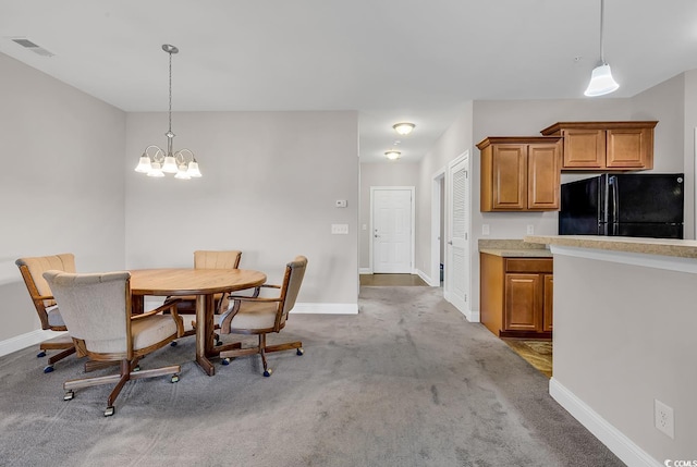 carpeted dining area with a notable chandelier