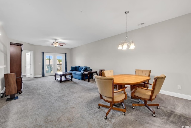 dining room featuring french doors, carpet floors, and ceiling fan with notable chandelier