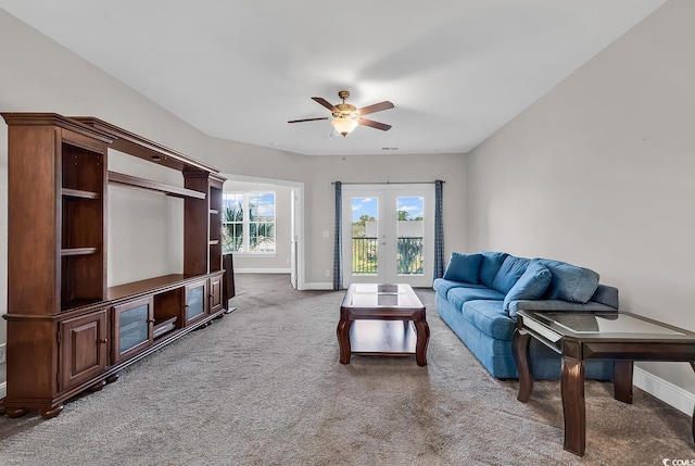 living room with french doors, carpet floors, and ceiling fan