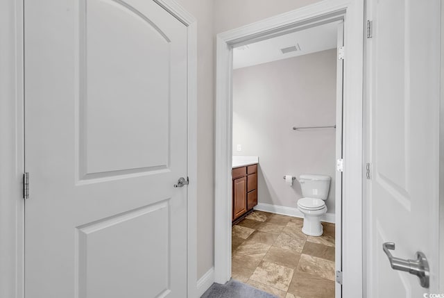 bathroom with toilet and vanity