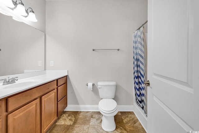 bathroom with vanity, curtained shower, and toilet