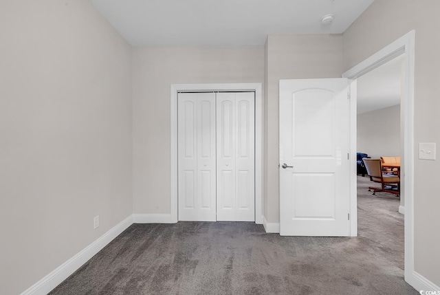 unfurnished bedroom featuring carpet and a closet