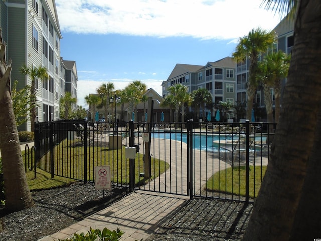 view of swimming pool featuring a lawn