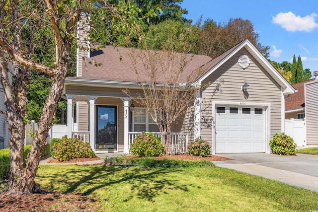 view of front of home with a garage and a front lawn