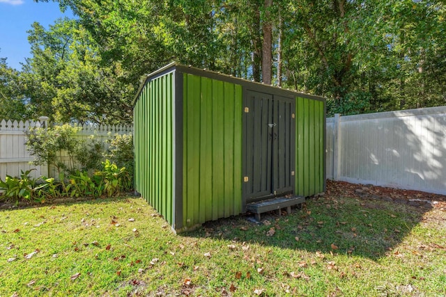 view of outbuilding with a lawn