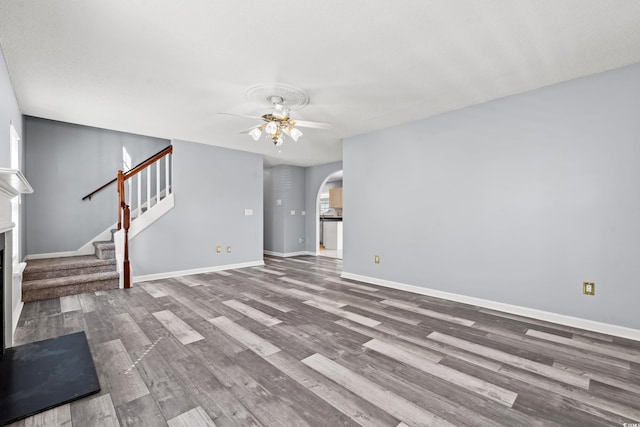 unfurnished living room with hardwood / wood-style flooring and ceiling fan