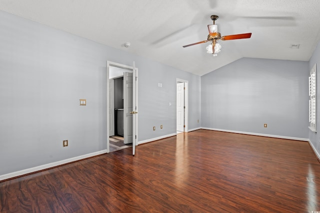 spare room with lofted ceiling, a textured ceiling, dark wood-type flooring, and ceiling fan