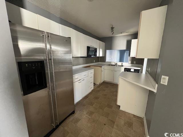 3831 Masters Ct Unit 137, Myrtle Beach, SC 29577 - kitchen featuring stainless steel refrigerator with ice dispenser, black microwave, white cabinets, and light countertops