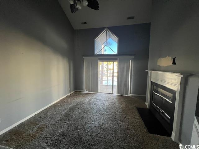 3831 Masters Ct Unit 137, Myrtle Beach, SC 29577 - unfurnished living room featuring high vaulted ceiling, carpet flooring, and a fireplace with flush hearth