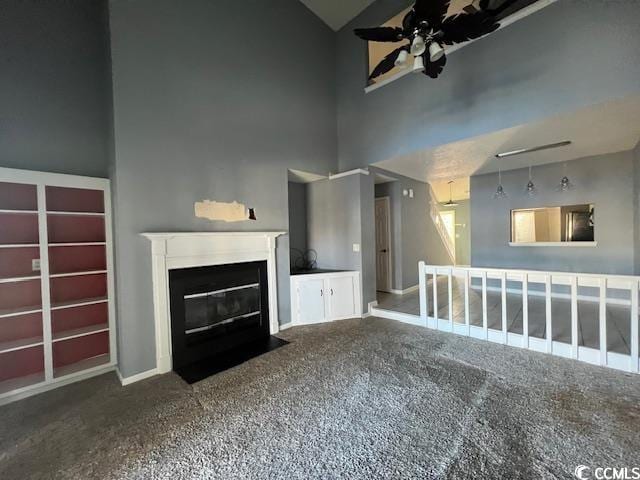 3831 Masters Ct Unit 137, Myrtle Beach, SC 29577 - unfurnished living room with a ceiling fan, carpet floors, a fireplace with flush hearth, and high vaulted ceiling