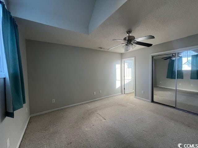 3831 Masters Ct Unit 137, Myrtle Beach, SC 29577 - unfurnished bedroom featuring multiple windows, carpet, ceiling fan, a textured ceiling, and a closet