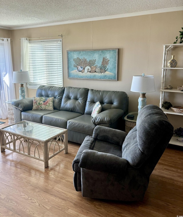 living area featuring a textured ceiling, crown molding, and wood finished floors